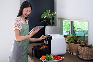 Girl with an Air Fryer - Difference Between an Air Fryer and a Microwave